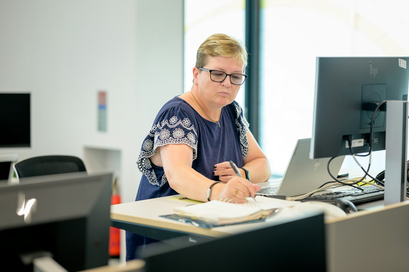 An advisor reviewing a client's financial figures at a desk